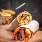 imgi_2_side-view-shawarma-with-fried-potatoes-board-cookware_176474-3215